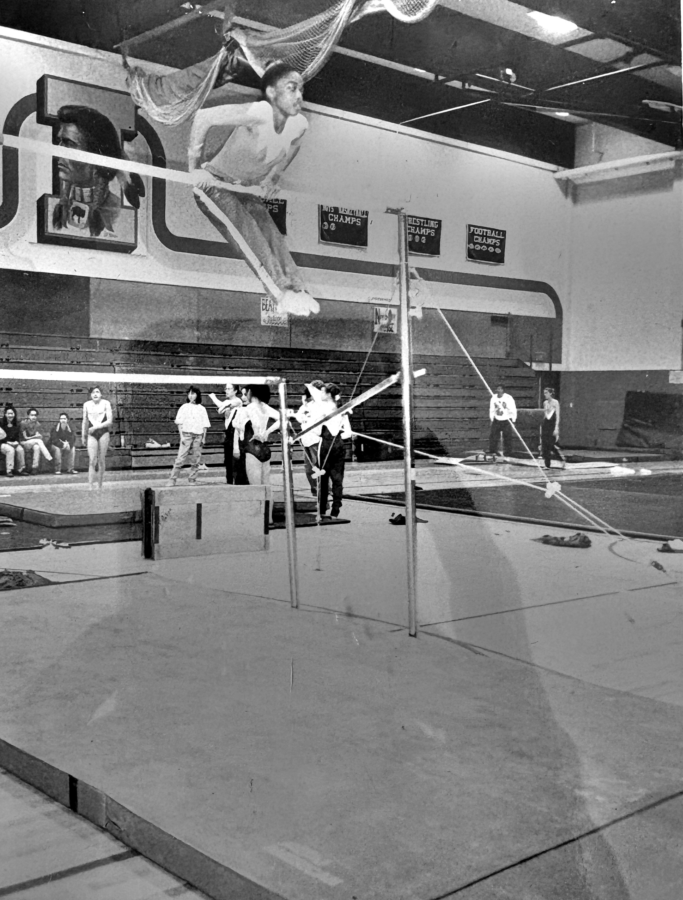 Seventh grade: mid-swing above the uneven bars in the school gym, the whole room watching.